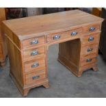 A teak twin pedestal desk with nine drawers