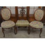A pair of Victorian standard chairs with floral tapestry seats to/w a Chippendale style dining chair