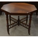 An Edwardian mahogany octagonal occasional table on ring turned supports united by cross stretchers