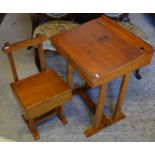 A vintage wooden child's school-type desk and box seat chair