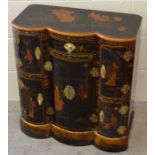 A small Chinese lacquered cabinet with central cupboard and drawer flanked by two cupboards