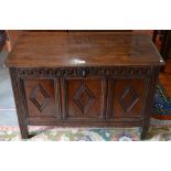 An 18th century English carved oak coffer with lunette frieze and diamond motif decoration, raised