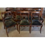 A set of seven matching Regency mahogany dining chairs with dark floral pad seats - six standard and