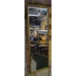 A bevelled rectangular mirror in decorative gilt frame
