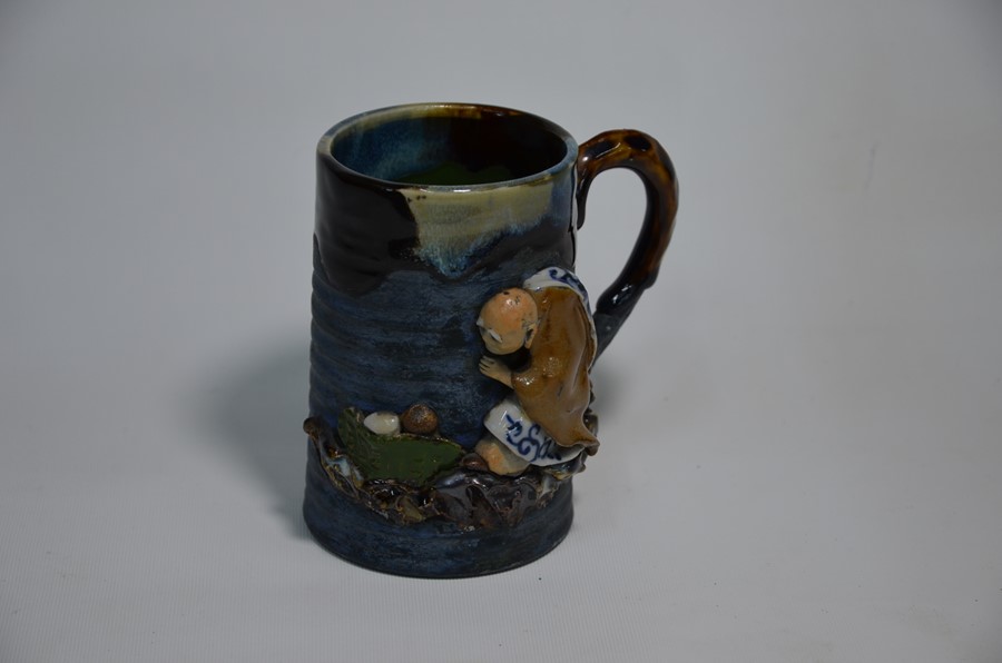 An early 20th century Asian luohan tankard, sancai style glaze