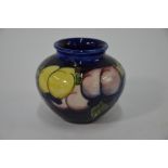 A Moorcroft small posy vase decorated with fruit and berries