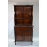 A Regency Rosewood faux-rosewood composite two part bookcase