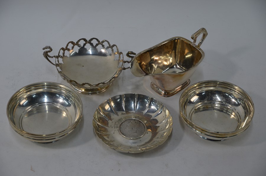 Four silver bowls and a cream jug