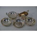 Four silver bowls and a cream jug