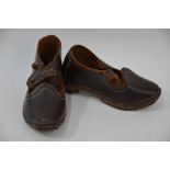 A pair of child's leather clogs