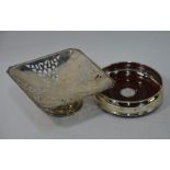 A silver bottle coaster and a pierced silver square comport