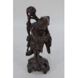 A Chinese carved hardwood figure of an immortal