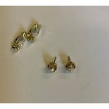 A pair of single stone diamond earrings
