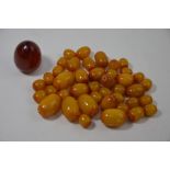 A collection of approx thirty-one amber-coloured beads