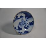 A Chinese blue and white bowl decorated with a landscape scene and three immortals