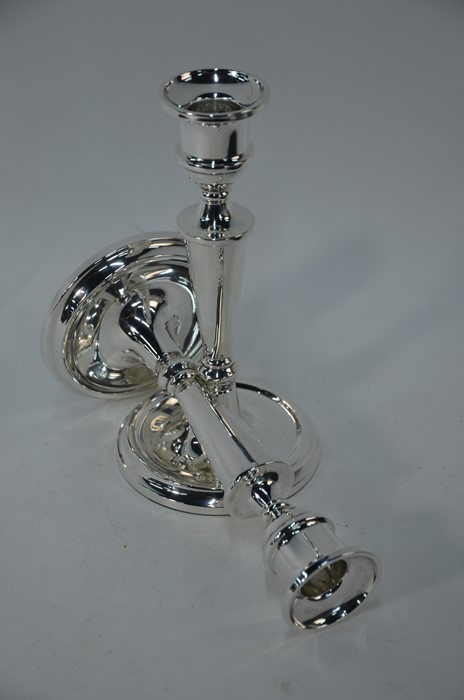 A pair of loaded silver baluster candlesticks