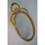 An oval giltwood wall mirror