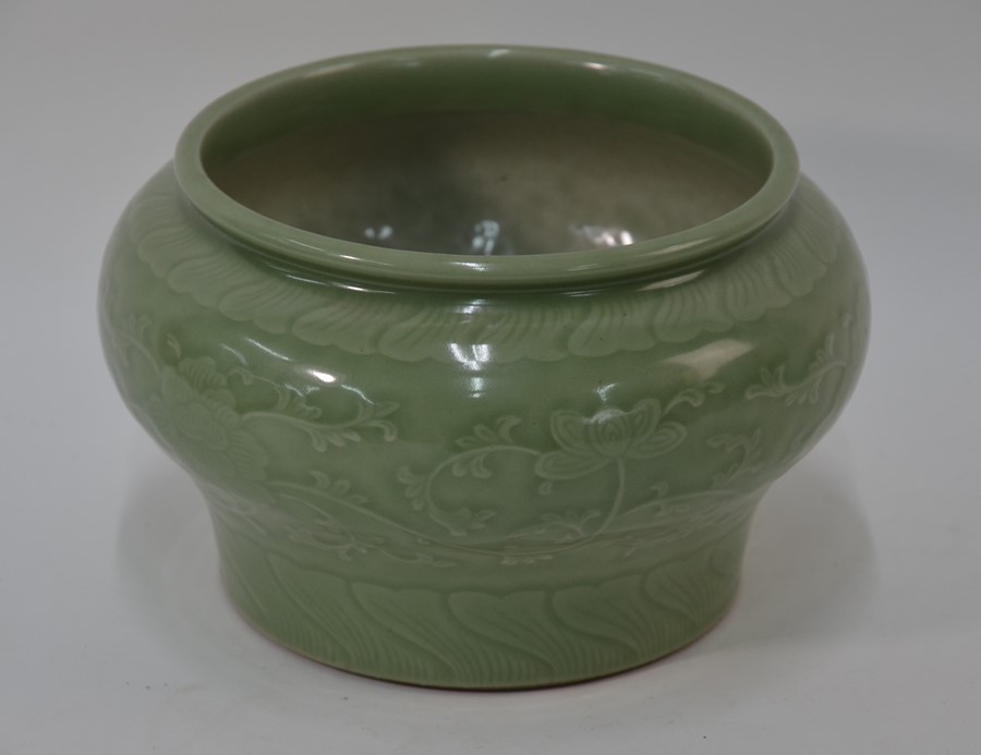 A Chinese celadon peony scroll jardiniere, Qing or later, 15 cm high