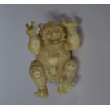 A Japanese 19th century carved ivory netsuke of an Oni