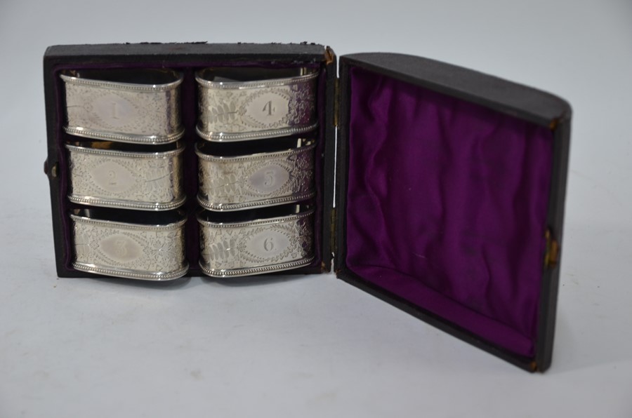 A Victorian cased set of six foliate-engraved silver napkin rings