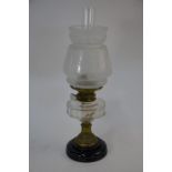An Edwardian oil lamp with frosted glass shade