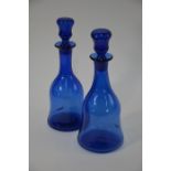 A pair of 19th century blue glass decanters