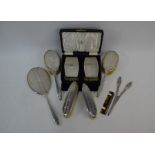 A cased pair of Art Deco style silver backed hairbrushes with matching comb