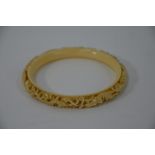 A Chinese carved ivory dragon bangle