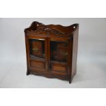 A late Victorian oak smoker's cabinet