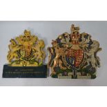 Two Elizabeth II cold painted Royal Warrant plaques