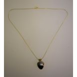A 9ct yellow gold pendant set with black mabe pearl