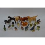 A collection of Beswick, Goebel and Royal Worcester animals and birds