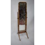 An antique walnut framed cheval mirror,