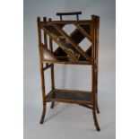 An antique oriental bamboo and lacquered gilt pictorial two-tier magazine rack