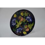 A contemporary Moorcroft plate decorated with Passion Fruit