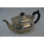 A half-reeded silver teapot