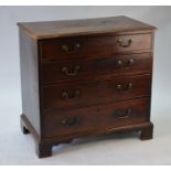 A George III oak chest of four long graduated drawers