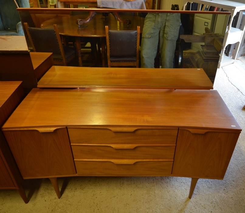 A 1960s 'Austin Suite' teak dressing table with wide rectangular mirror, two cupboards flanking