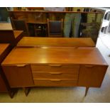 A 1960s 'Austin Suite' teak dressing table with wide rectangular mirror, two cupboards flanking