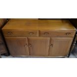 An Ercol elm sideboard with two drawers over three cupboard doorsgood condition