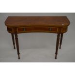 A mahogany crossbanded kidney shaped console table with frieze drawer, raised on turned and fluted