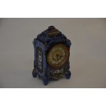 A late 19th century French ceramic clock, blue glazed with floral decoration and gilt highlights,