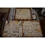 A large collection of ceramic, wooden, glass and metal thimbles in a fitted teak box with three