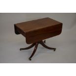 A 19th century mahogany sofa table, the drop leaf top with end drawer raised on turned column and