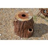 A naturalistic stoneware garden seat in the form of a tree stump