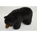 A large standing stuffed black bear toy by Ditz, 40 cm high x 75 cm long