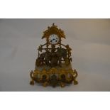 A Continental spelter and alabaster garniture mantle clock featuring horse and market seller beneath