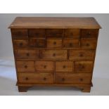 An Indonesian hardwood apothecary chest with arrangement of 19 small drawers, 95 cm high x 105 cm