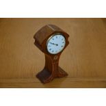 An Art Nouveau mantle clock of balloon form, with satinwood and mother of pearl inlay, white ceramic