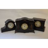 Three ebonised architectural mantle clocks with circular dials and twin train movements, 32 cm